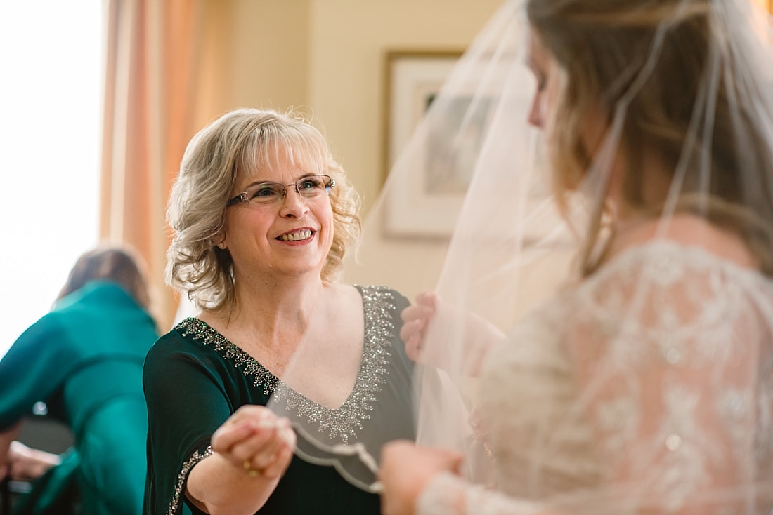 mother of the bride putting the wedding veil on her daughter in Collierville, TN