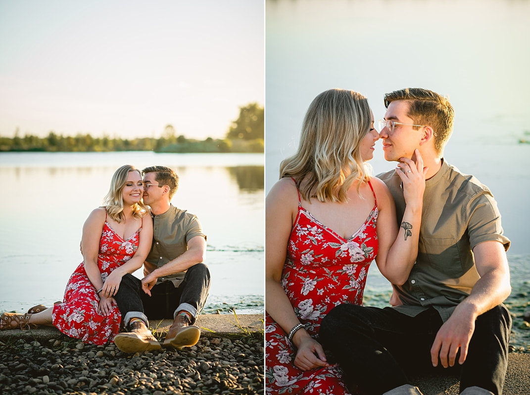 couple posing for engagement photos by the lake at shelby farms park in memphis, tn