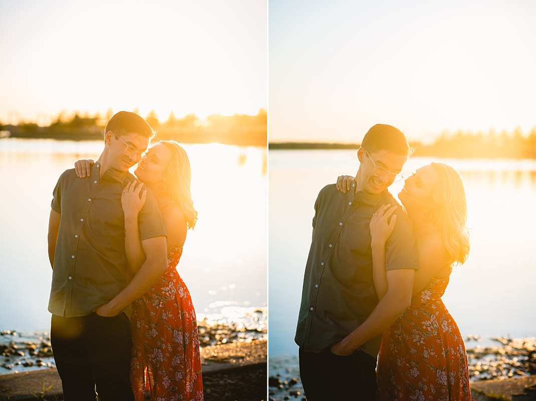 couple posing for engagement photos by the lake at shelby farms park in memphis, tn