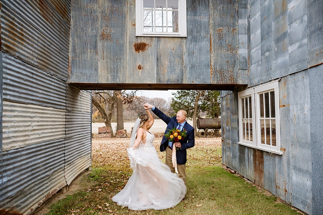 Bride and groom dancing at the old cotton gin at Green Frog Farm during wedding photos with Sarah Morris Photography