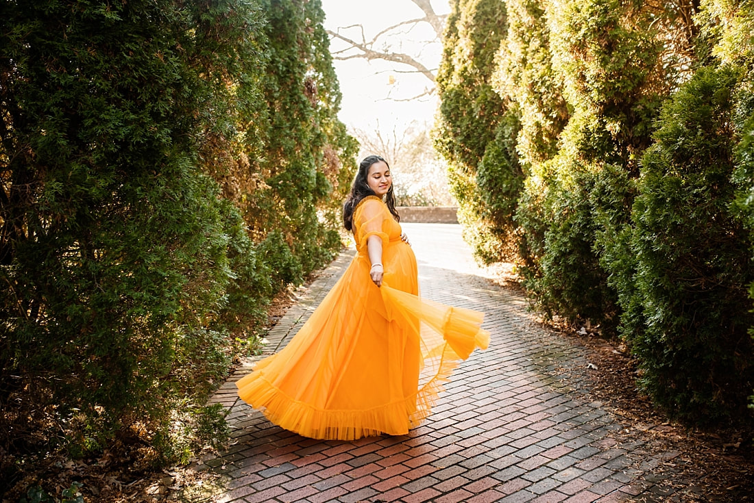 pregnant lady twirling Indian dress at memphis botanic garden