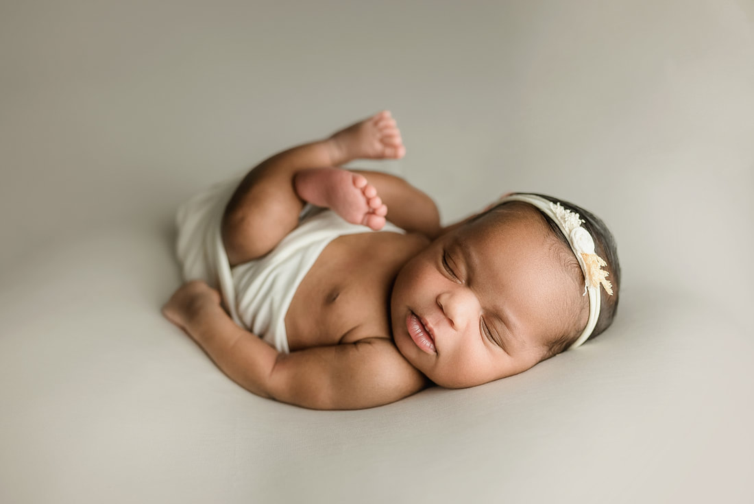 newborn baby girl sleeping during her newborn photo shoot with Sarah Morris Photography