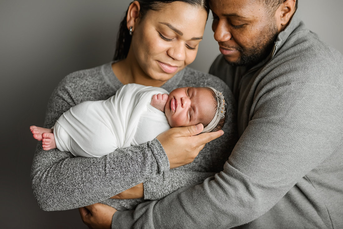 portrait of new parents with newborn baby in Memphis, TN