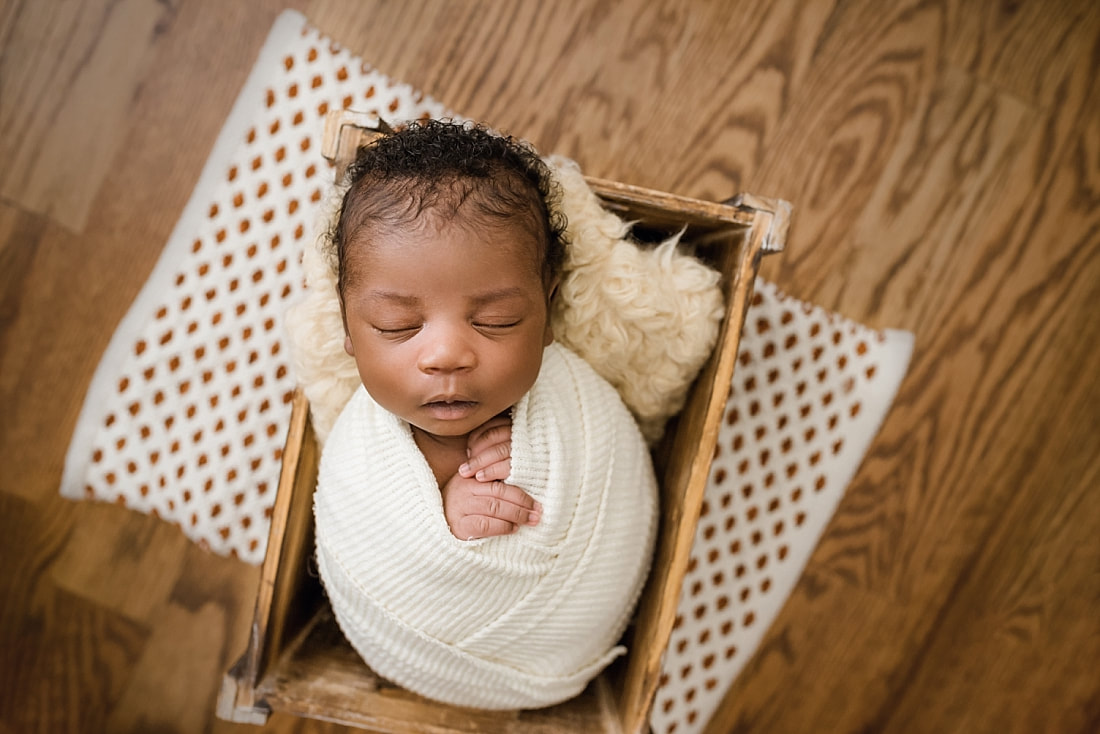 newborn baby sleeping in wooden box for newborn session with sarah morris photography