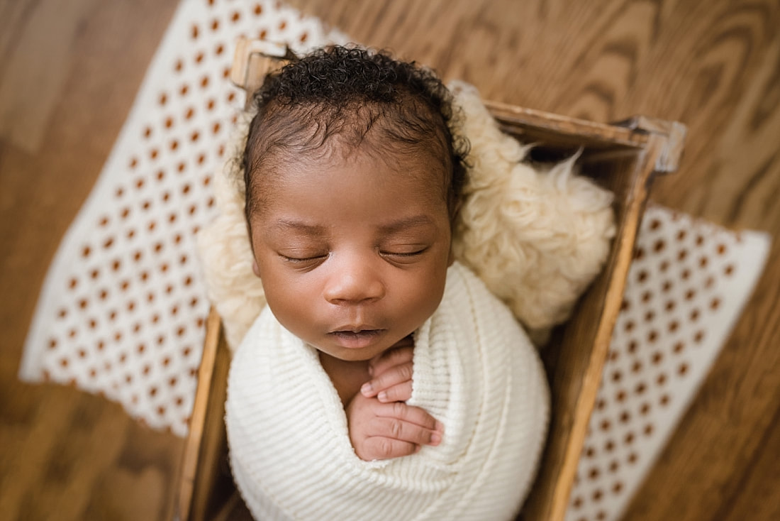 newborn baby sleeping in wooden box for newborn session with sarah morris photography