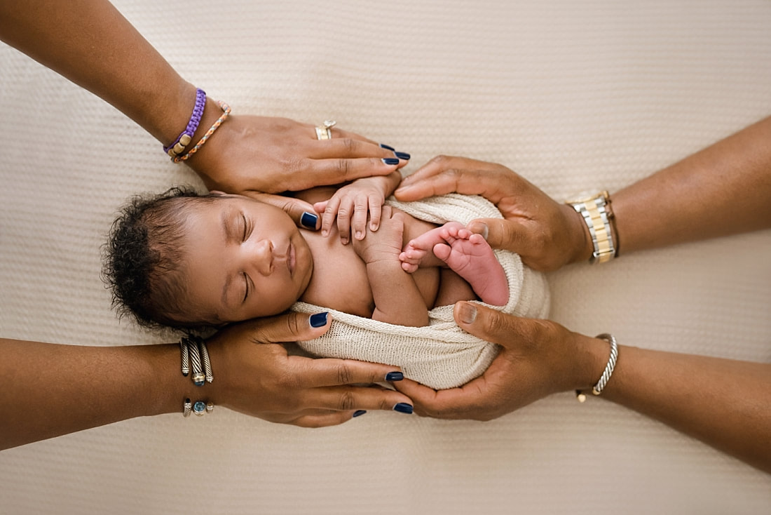 newborn baby with mom and dad's hands for newborn session in Memphis, TN