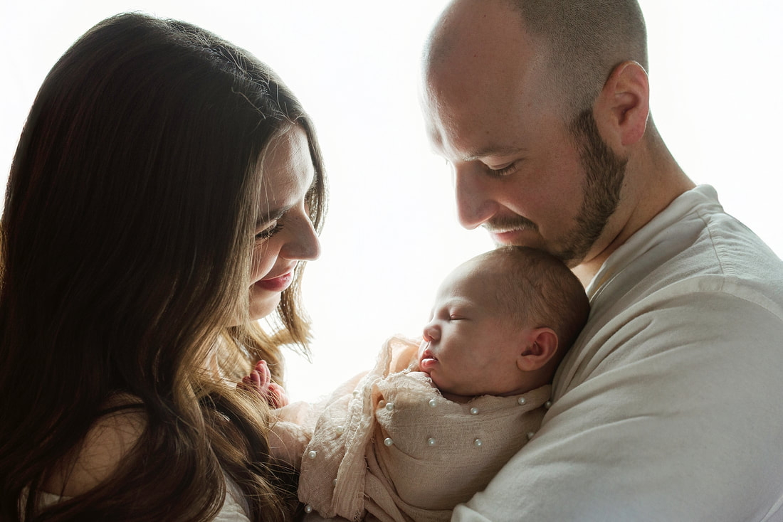 portrait of new parents with newborn baby in Memphis, TN