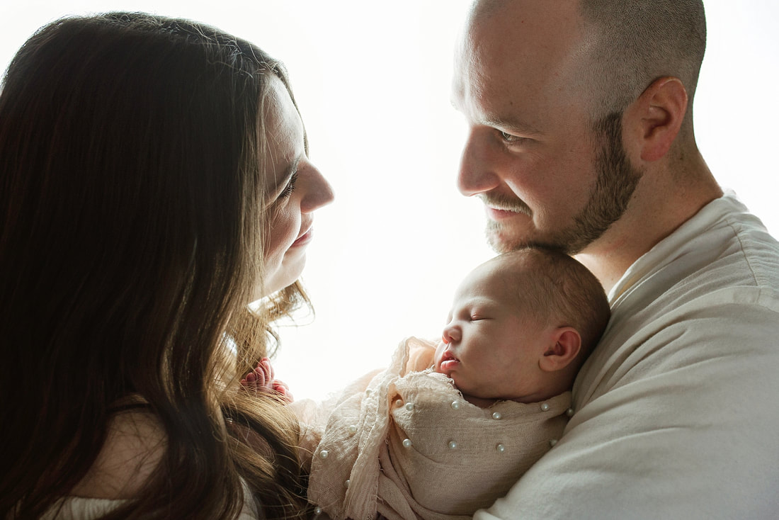 portrait of new parents with newborn baby in Memphis, TN