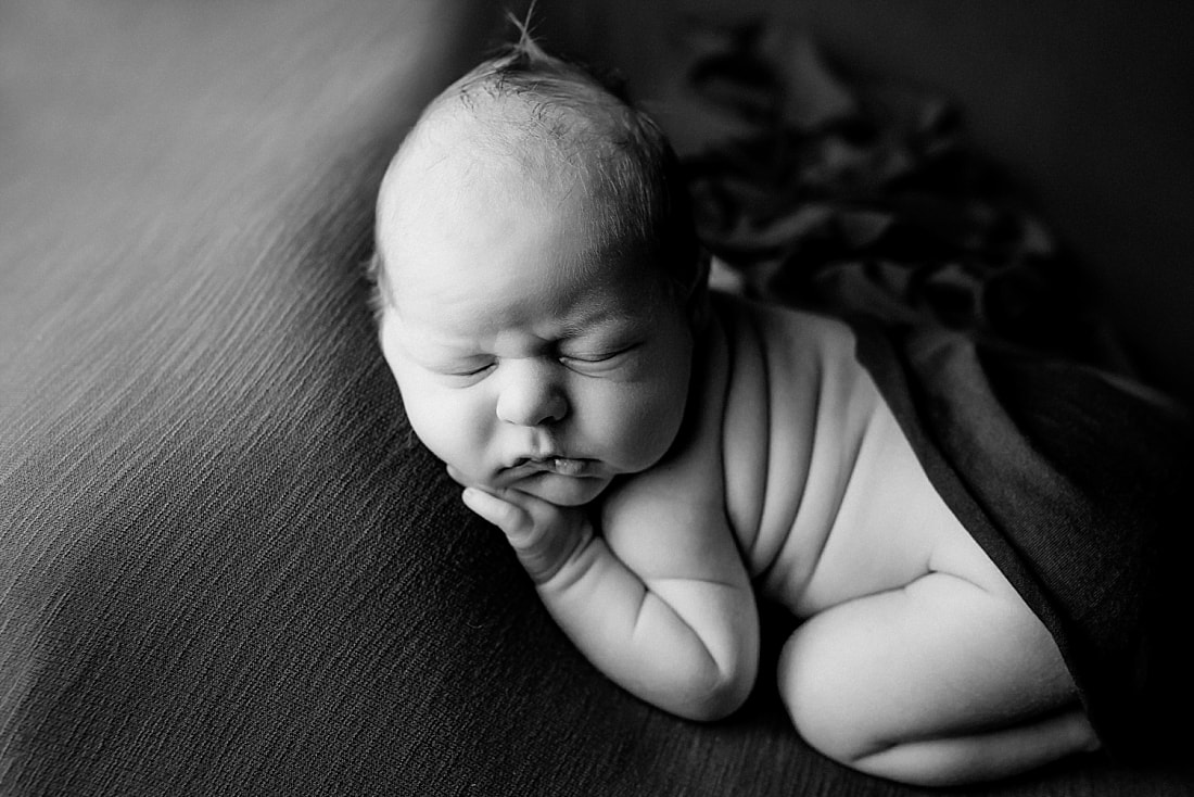 newborn baby boy posed and sleeping on green blanket in Memphis, TN