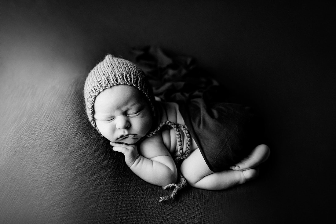 newborn baby boy posed and sleeping on green blanket in Memphis, TN