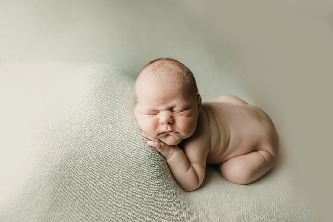 newborn baby boy posed and sleeping on tan blanket in Memphis, TN