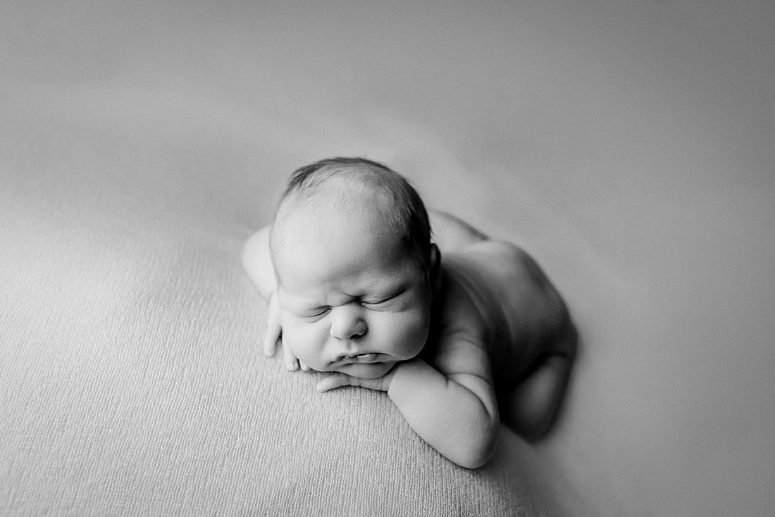 newborn baby boy posed and sleeping on tan blanket in Memphis, TN