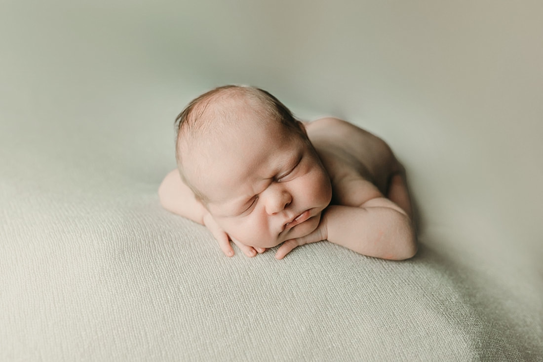 newborn baby boy posed and sleeping on tan blanket in Memphis, TN