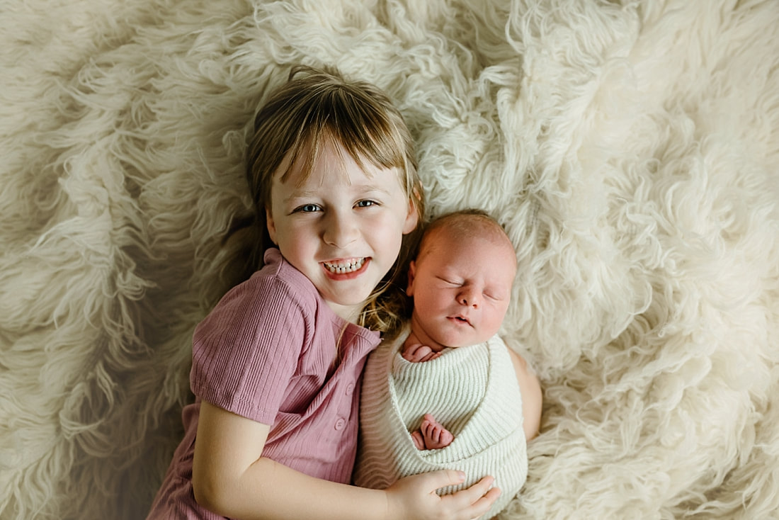 big sister holding newborn baby brother in Memphis, TN