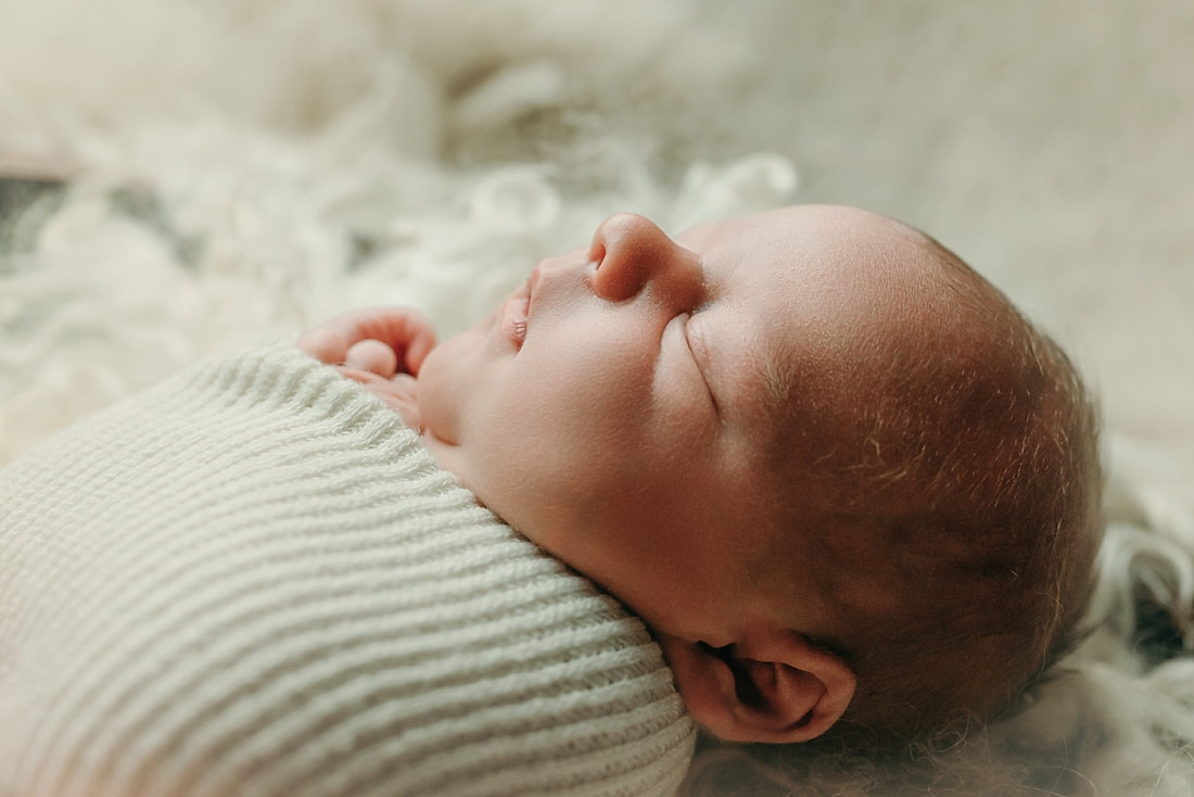 newborn baby wrapped in ivory blanket for newborn portraits in Memphis, TN